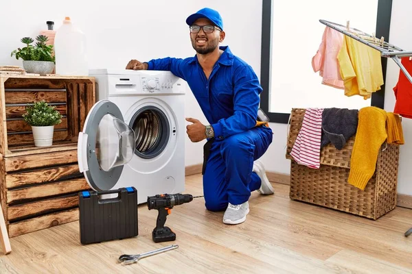 Technician repairing washing machine
