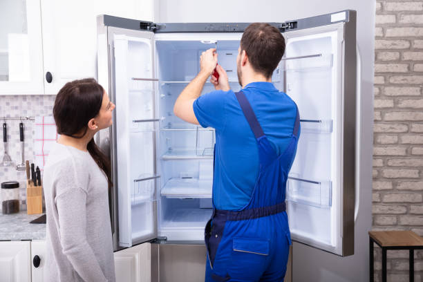 Technician repairing refrigerator