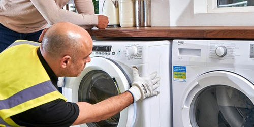 Technician repairing washing machine